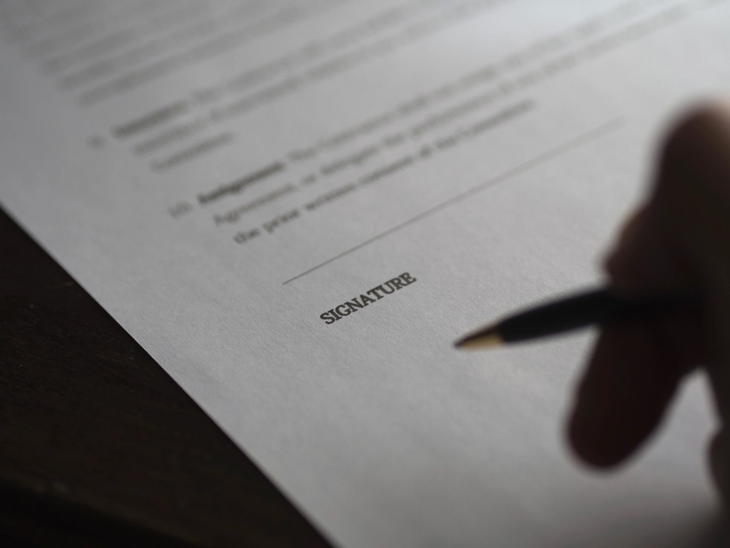 Home buyer signing a purchase agreement
