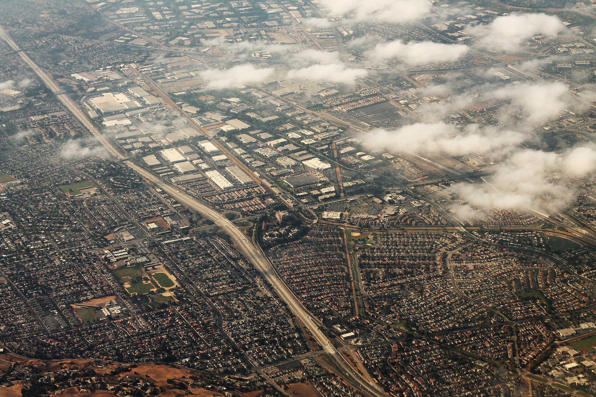 Aerial view of Milpitas, California, with its residential neighborhoods framed by the Santa Clara Valley foothills