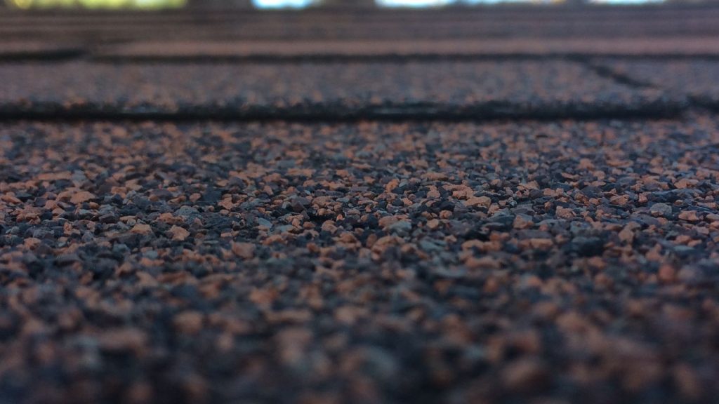 Close up of architectural asphalt roof shingles showing texture