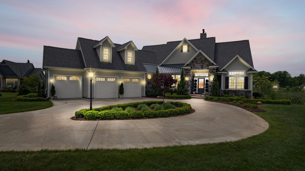 Suburban home at dusk with warm exterior lighting