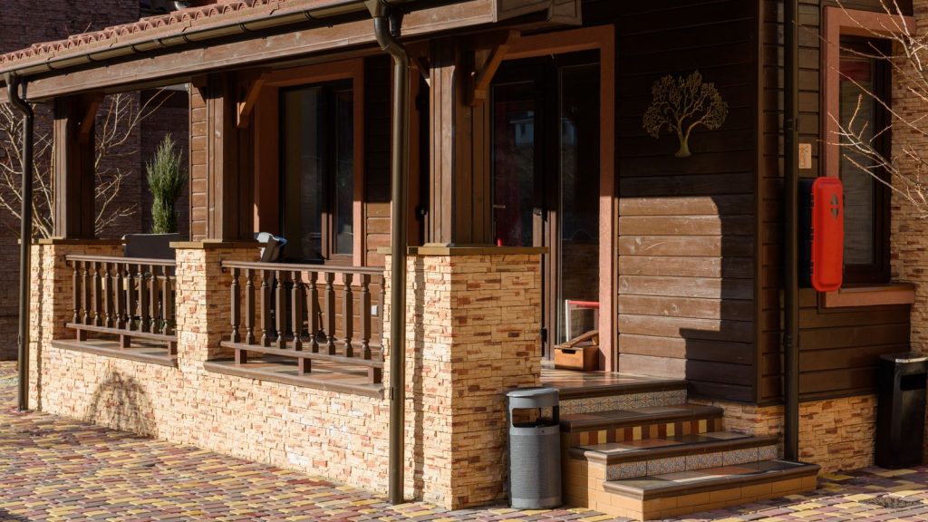 House exterior with stone accent wall and warm entry lighting
