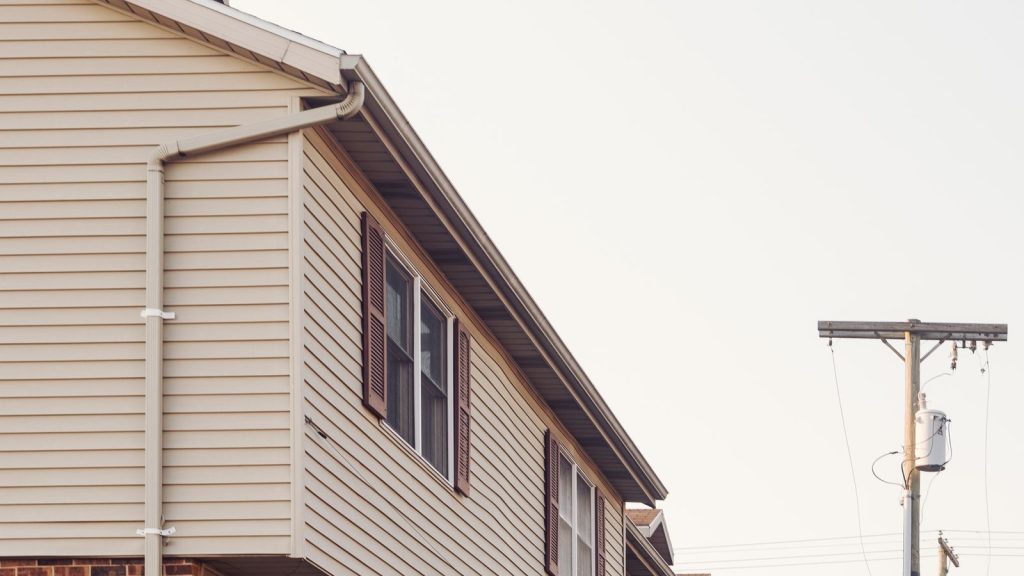 Row of suburban houses with siding and brick exteriors