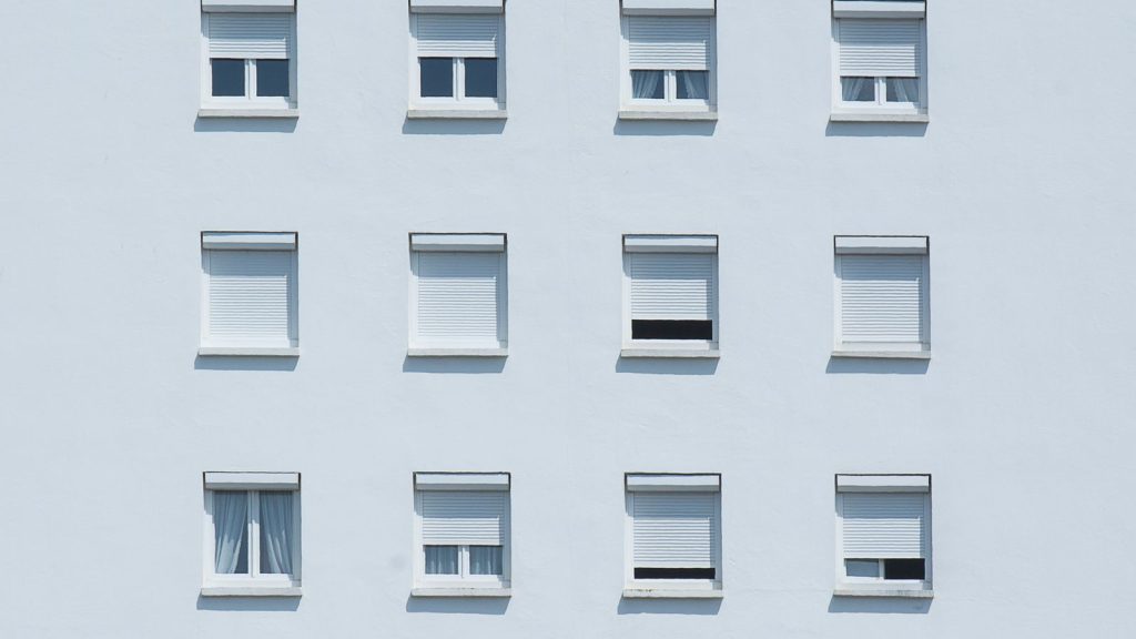 Symmetrical white framed windows on a clean residential facade