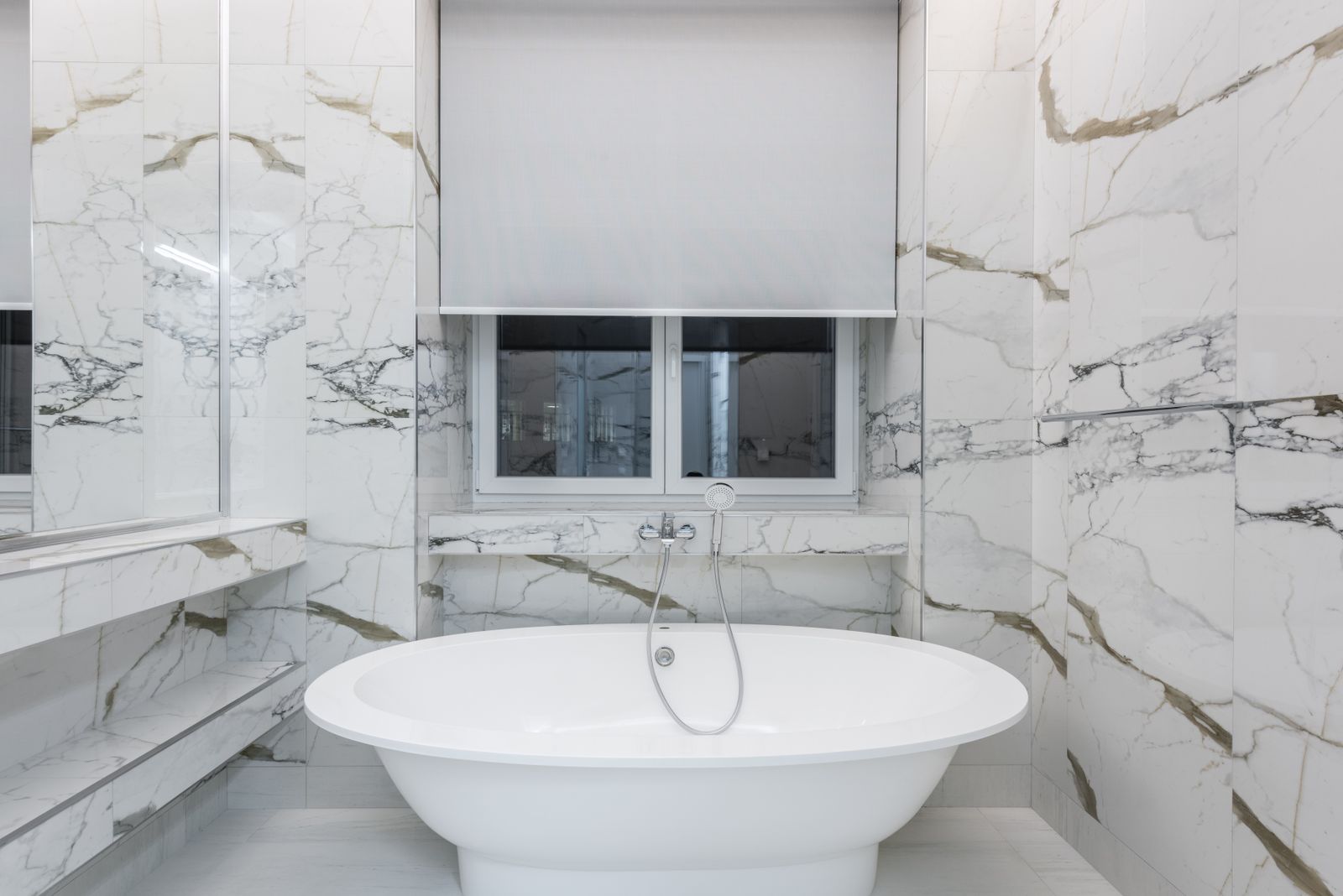 Modern bathroom with luxurious marble design and sleek freestanding bathtub