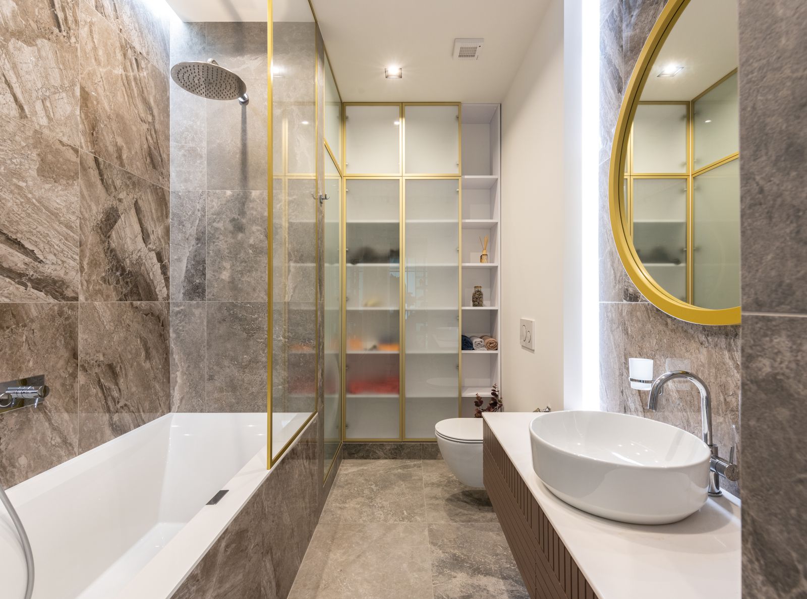 Modern light bathroom with white sink, counter, mirror and bath