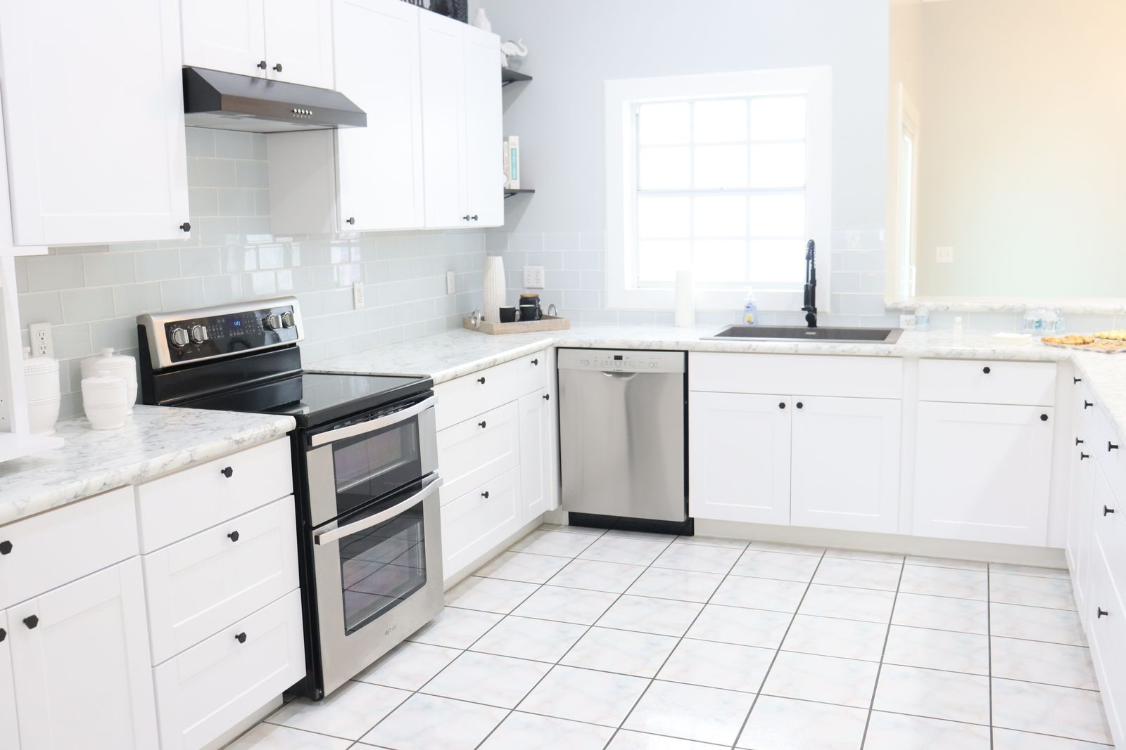 Bright, spacious modern kitchen with white cabinets and natural light