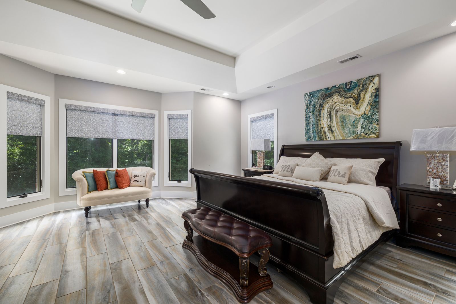 Sophisticated modern bedroom with luxurious furniture and large windows