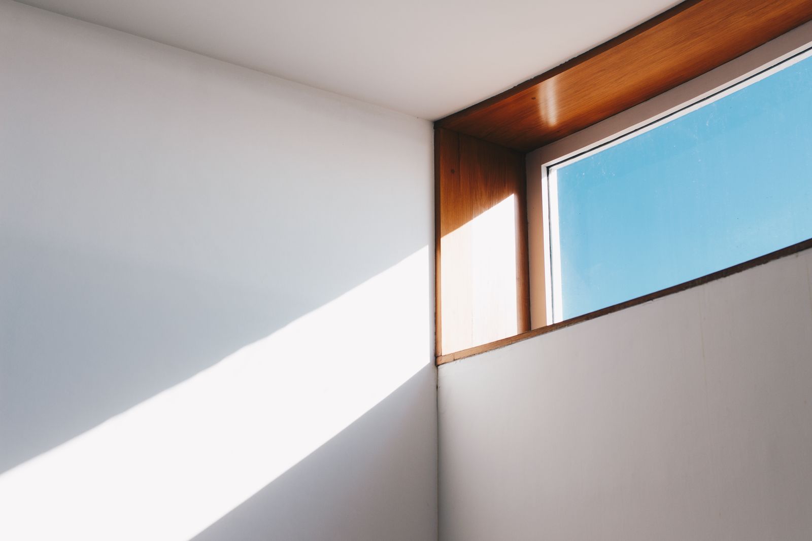 Clear glass window with brown and white wooden frame